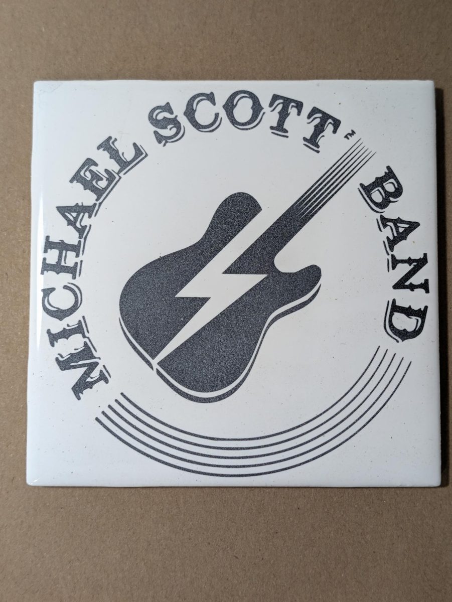 Band logo laser engraved on a white ceramic tile