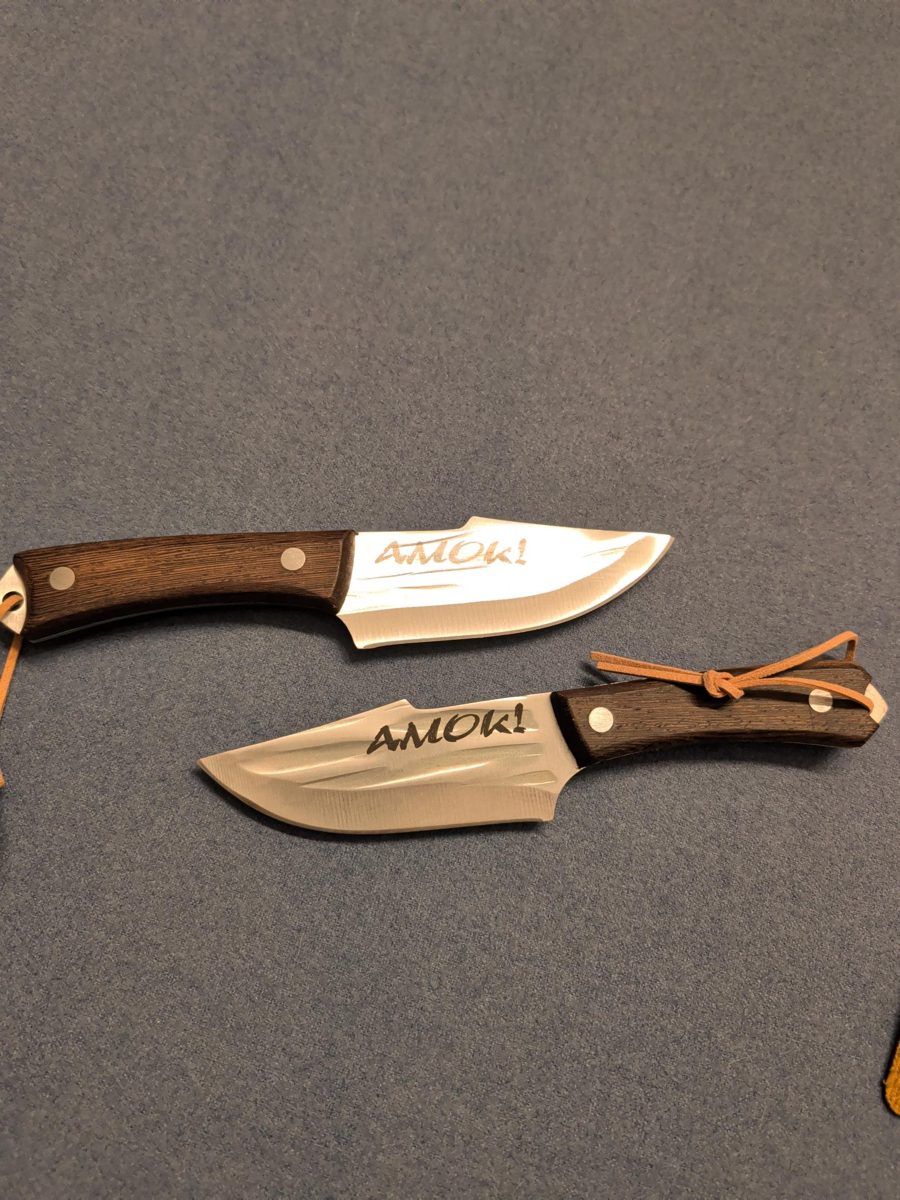 Two knives with laser engraved lettering on the blades